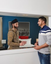 Two students chatting in a hotel bedroom mock-up
